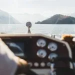 Blick auf die Berge des Comer Sees durch das Fenster einer Yacht. Silhouetten von Hügeln am Horizont. Luxus-Urlaub und Kreuzfahrt-Konzept. Bootsfahrt. Yachting in Italien.
