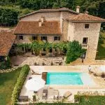 aerial view of couple relaxing at swimming pool near villa in Italy