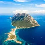 Spektakuläre Luftaufnahme der Insel Tavolara, gebadet in einem klaren, türkisfarbenen Meer, Sardinien, Italien.